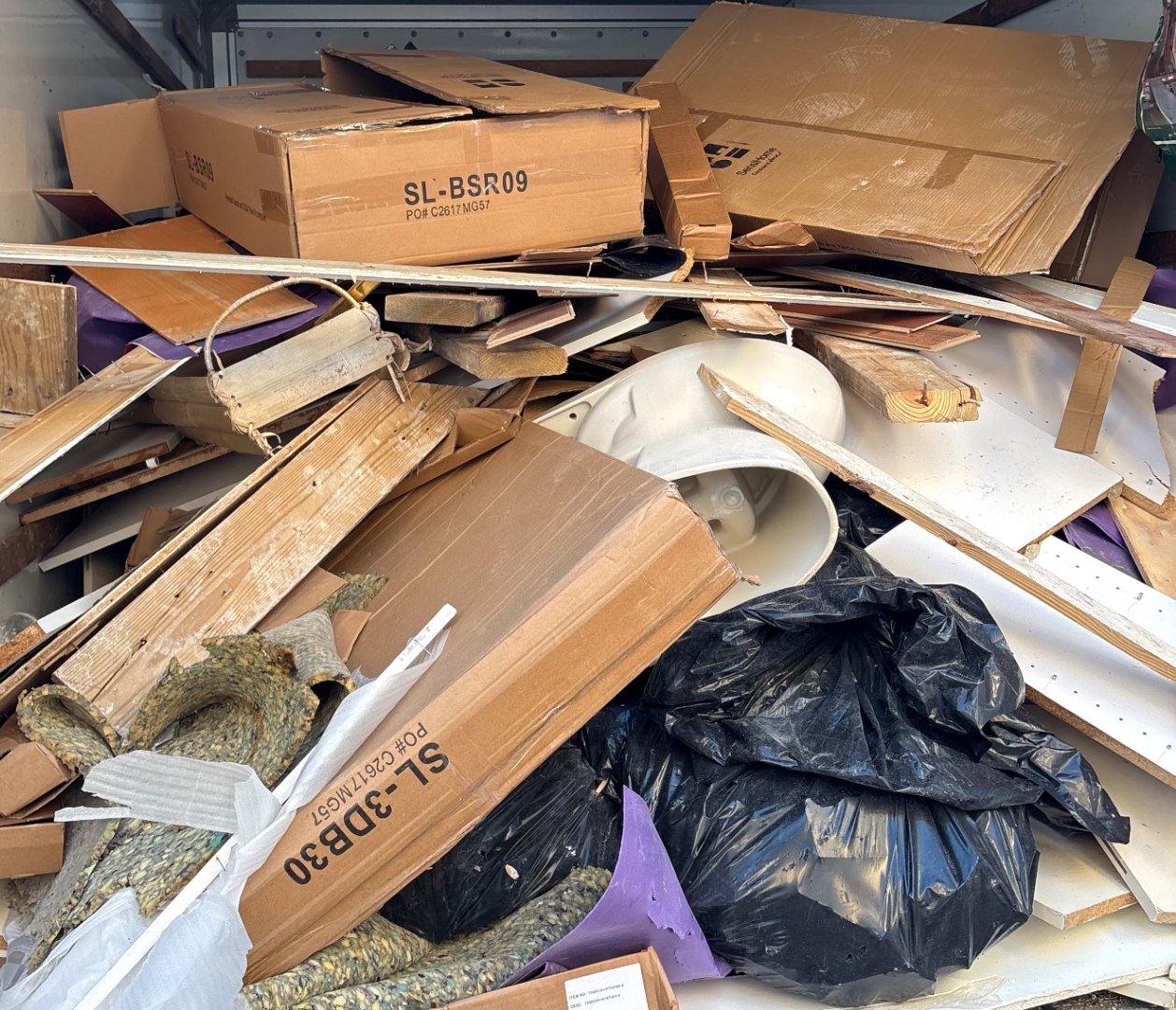 Truckload of demolition debris, cabinets and carpet hauled away by CoastAwayJunk