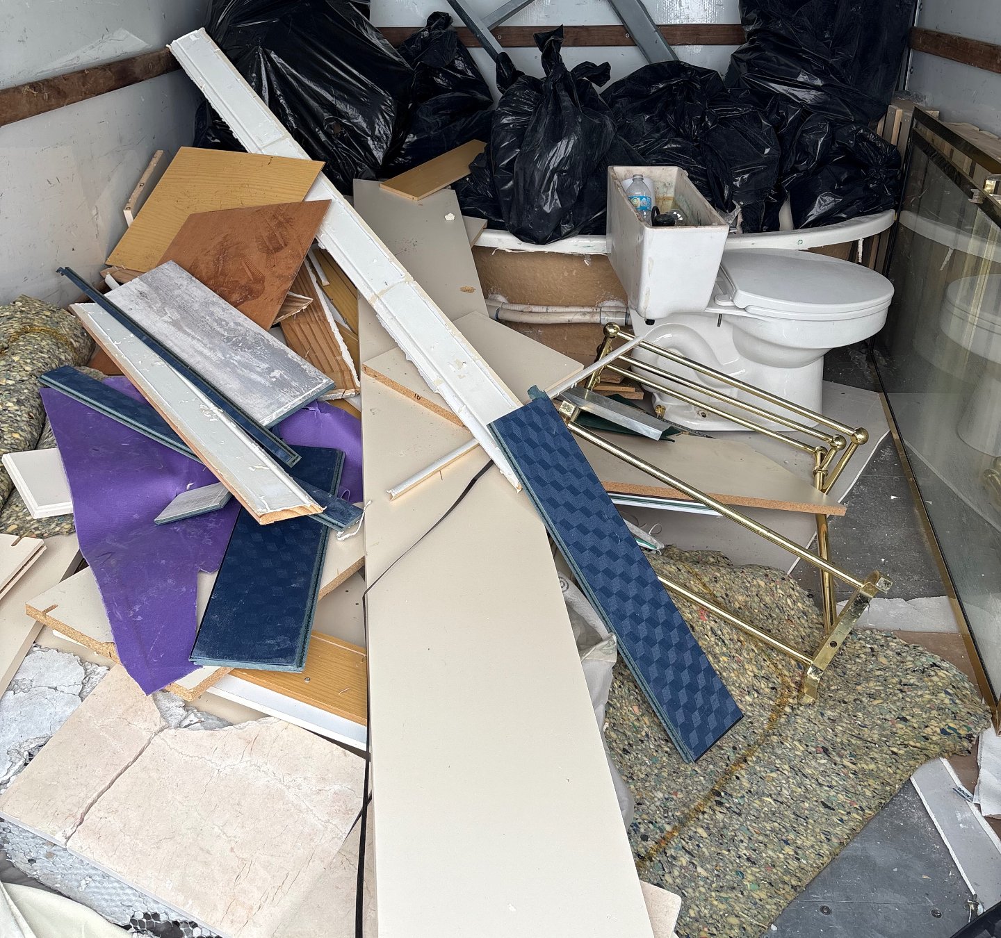 Bathroom tear-out debris including tub, toilet and tile loaded by CoastAwayJunk